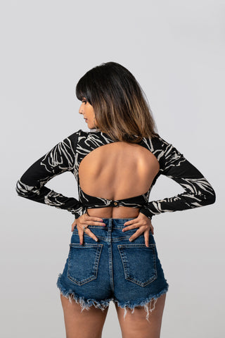 Moonchild Bodysuit in black abstract print, made from organic cotton with full sleeves and a fitted silhouette.