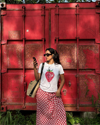 A model wearing strawberry graphic print tee
