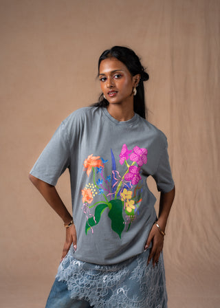 Model wearing a soft grey washed Wildflower oversized tee