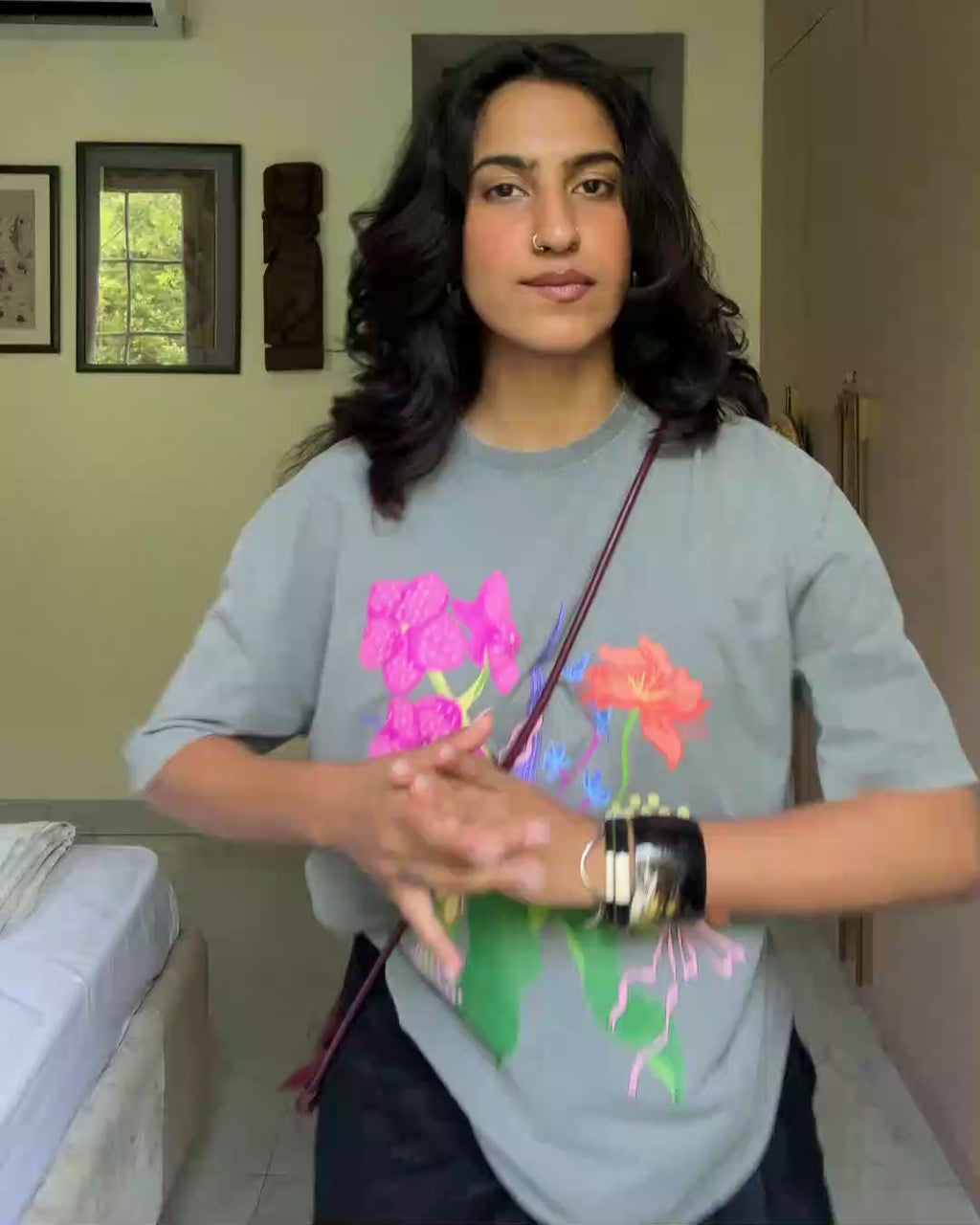 A model dancing in grey botanical print wildflower oversized tee